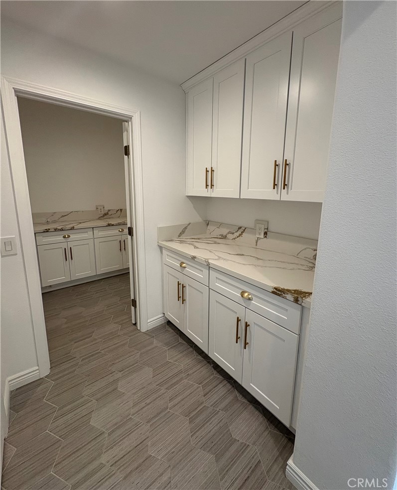 1324 Swan Loop East Upland, CA 91784 - Photo 7 of 27 a kitchen with white cabinets and sink