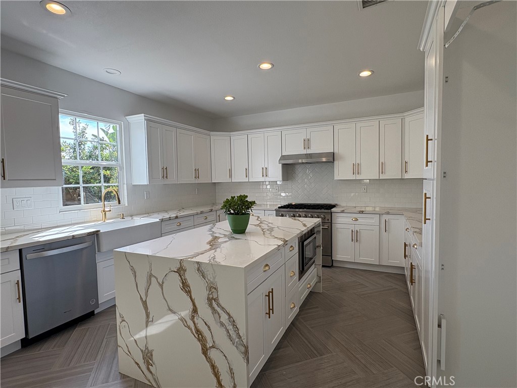 1324 Swan Loop East Upland, CA 91784 - Photo 8 of 27 a kitchen with granite countertop white cabinets and white appliances