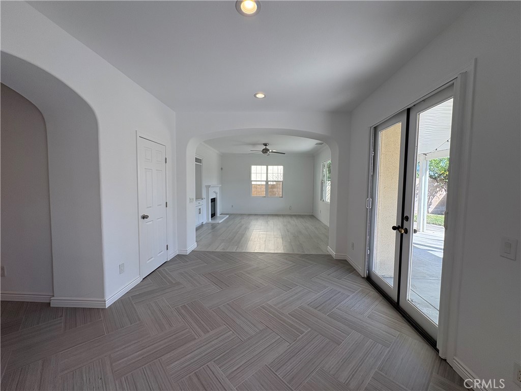 1324 Swan Loop East Upland, CA 91784 - Photo 9 of 27 a view of wooden floor and windows in an empty room