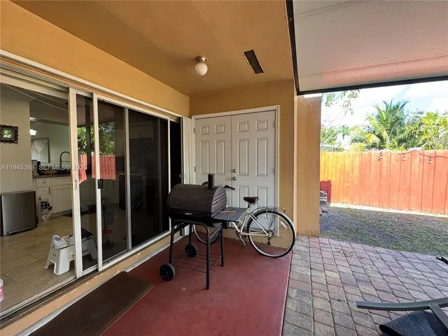 a view of a porch with chairs and backyard