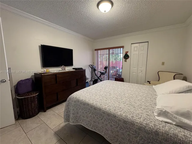 a bedroom with a bed and television