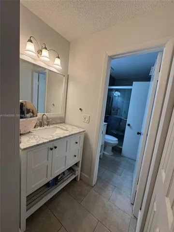 a spacious bathroom with a double vanity sink and a mirror