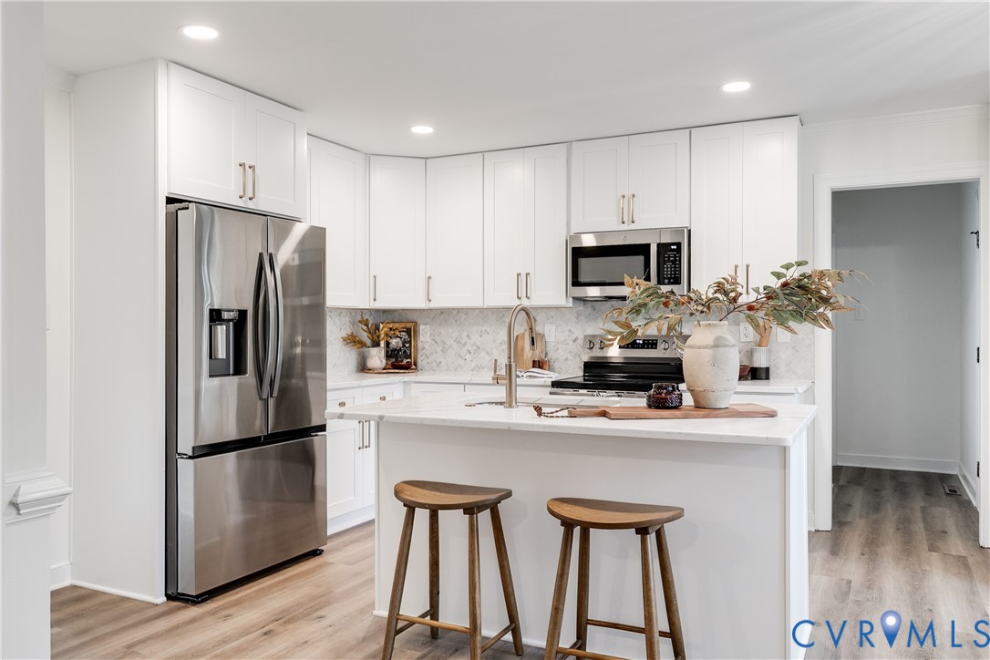 2802 Fairgate Road Midlothian, VA 23112 - Photo 11 of 38 a kitchen with stainless steel appliances a refrigerator stove microwave and cabinets