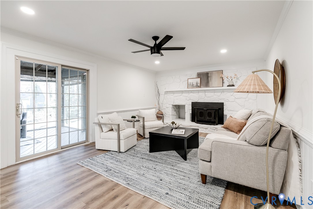 2802 Fairgate Road Midlothian, VA 23112 - Photo 14 of 38 a living room with furniture a fireplace and a floor to ceiling window