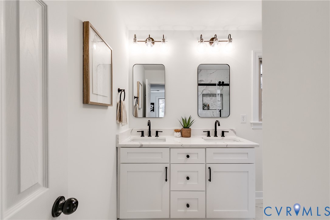 2802 Fairgate Road Midlothian, VA 23112 - Photo 20 of 38 a bathroom with double vanity sinks and a mirror