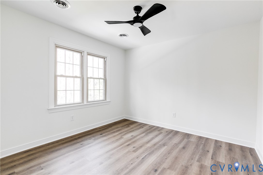 2802 Fairgate Road Midlothian, VA 23112 - Photo 24 of 38 an empty room with a window and a ceiling fan