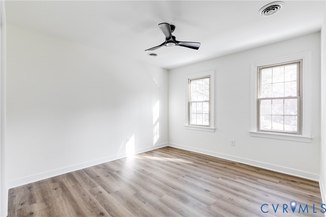 2802 Fairgate Road Midlothian, VA 23112 - Photo 26 of 38 an empty room with wooden floor ceiling fan and windows