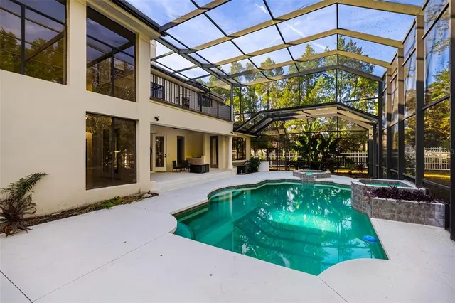 a view of a hallway with wooden floor and windows