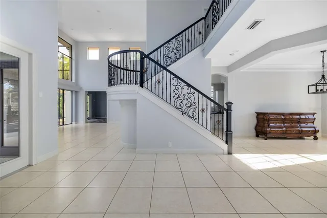 a view of entryway and hall with dining room and furniture