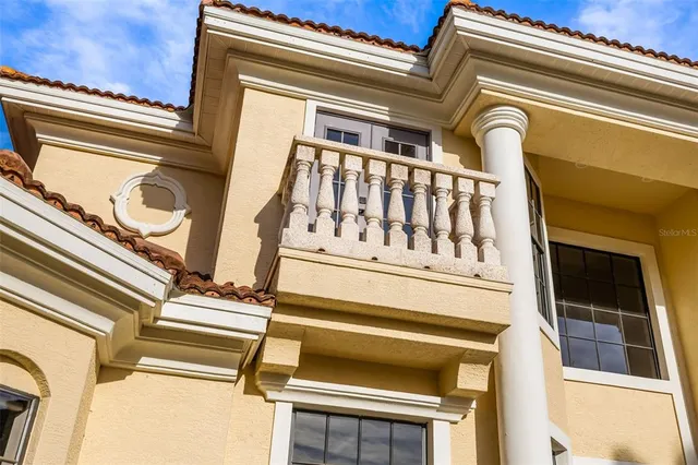 an aerial view of a house with swimming pool and large trees