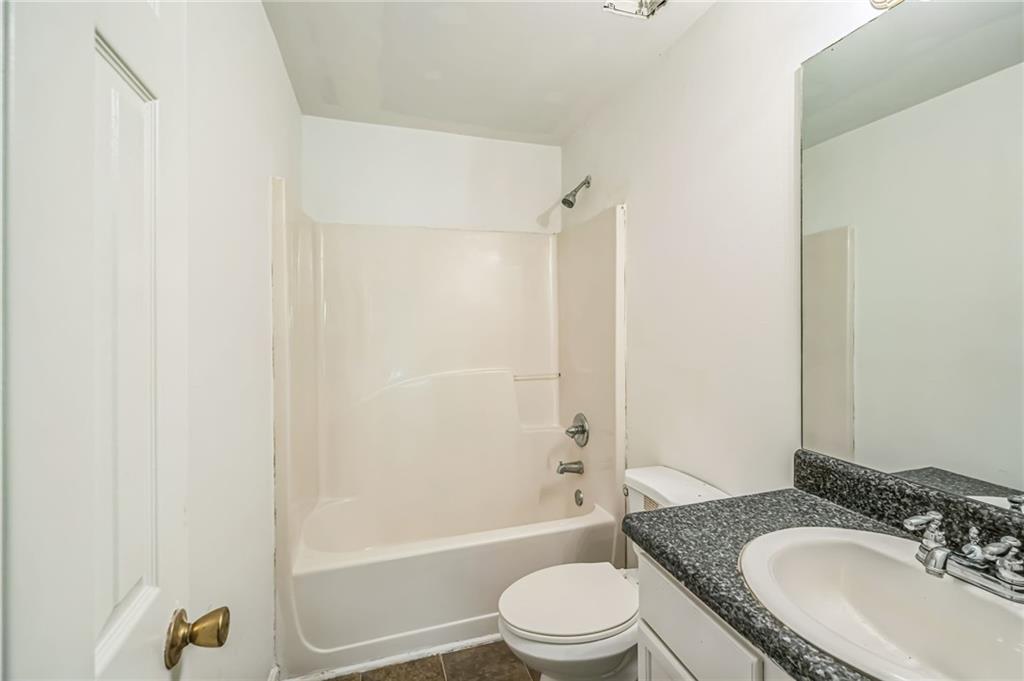 2045 Baker Road Northwest, Unit A Atlanta, GA 30318 - Photo 11 of 15 a bathroom with a granite countertop sink toilet and shower