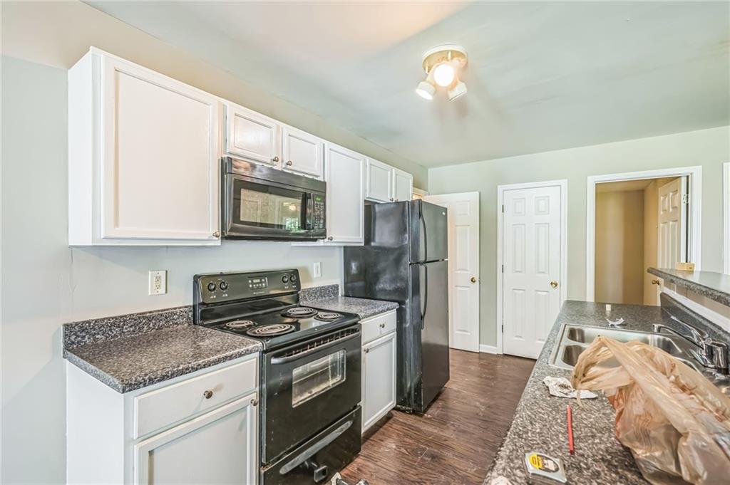 2045 Baker Road Northwest, Unit A Atlanta, GA 30318 - Photo 14 of 15 a kitchen with stainless steel appliances granite countertop a stove a refrigerator and a sink