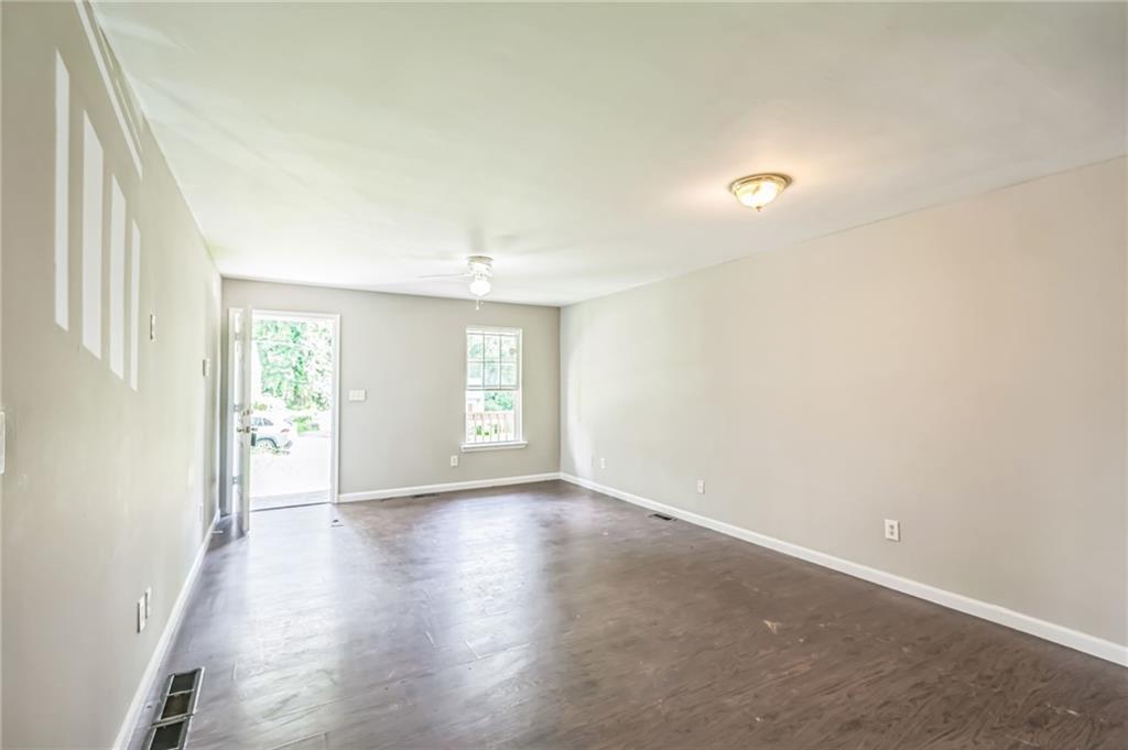 2045 Baker Road Northwest, Unit A Atlanta, GA 30318 - Photo 5 of 15 an empty room with wooden floor and windows