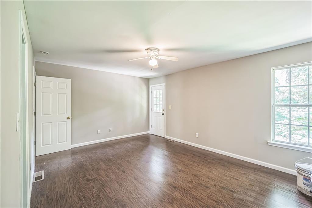 2045 Baker Road Northwest, Unit A Atlanta, GA 30318 - Photo 7 of 15 an empty room with windows and fan