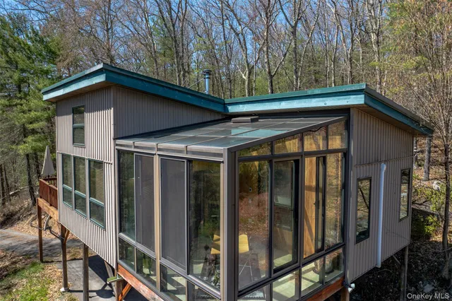 a view of wooden house with a large window