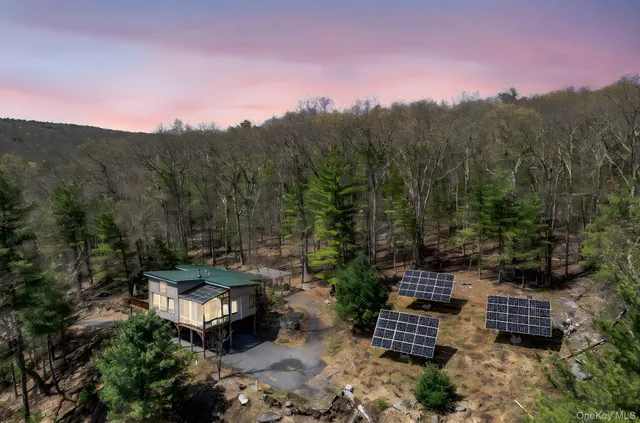 a view of a chairs and table in the backyard