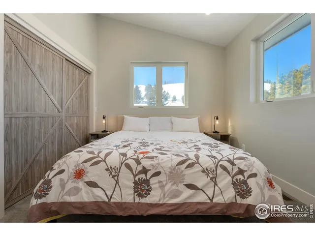 a bedroom with a bed and a night stand