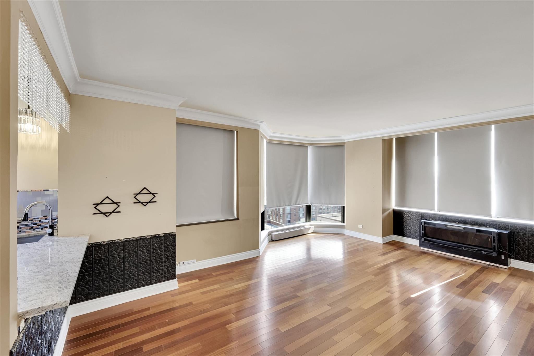 380 Rector Place, Unit 15E Manhattan, NY 10280 - Photo 16 of 31 Spare room with a sink, light wood-style flooring, baseboards, and ornamental molding