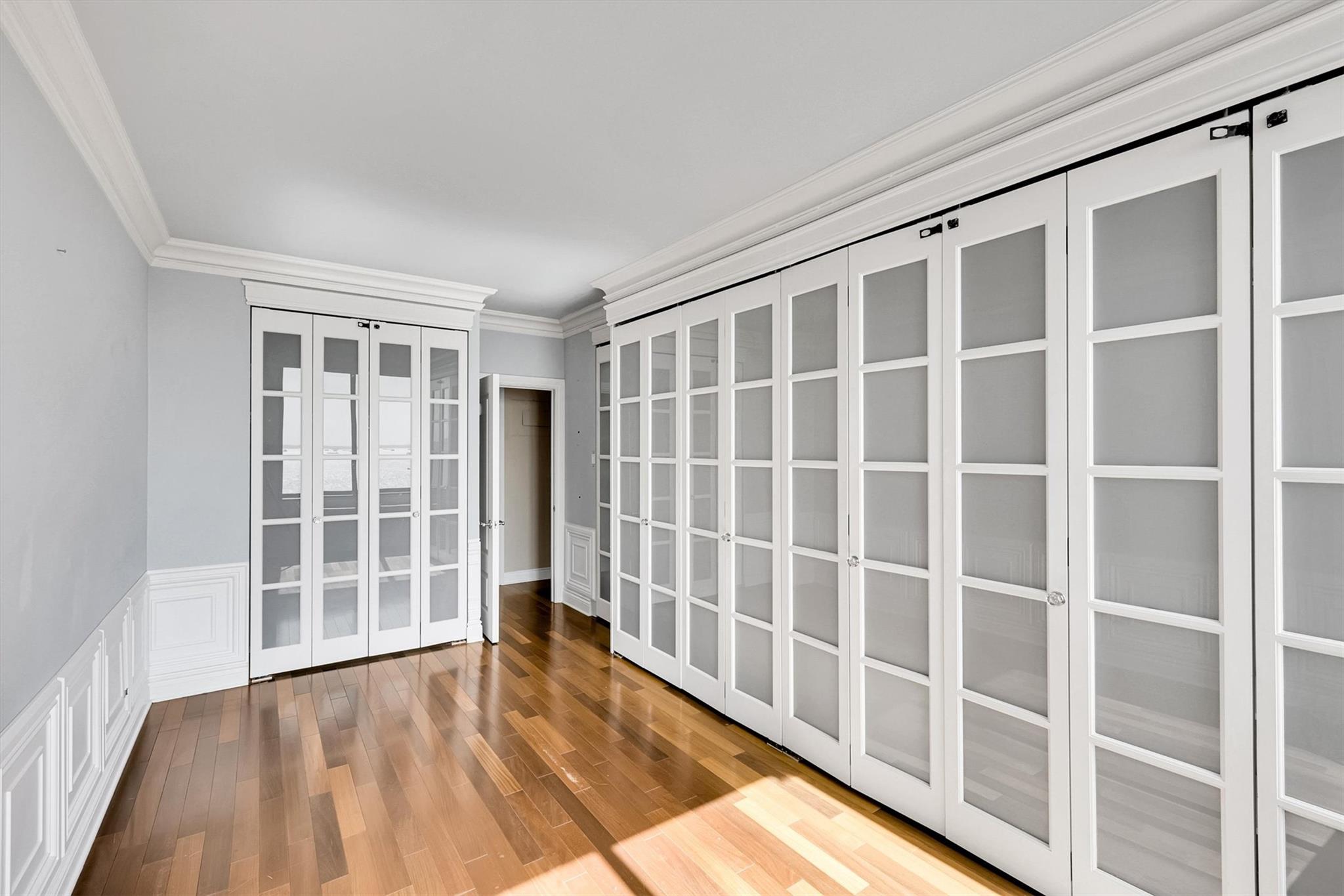 380 Rector Place, Unit 15E Manhattan, NY 10280 - Photo 25 of 31 Spare room with french doors, wood finished floors, and crown molding