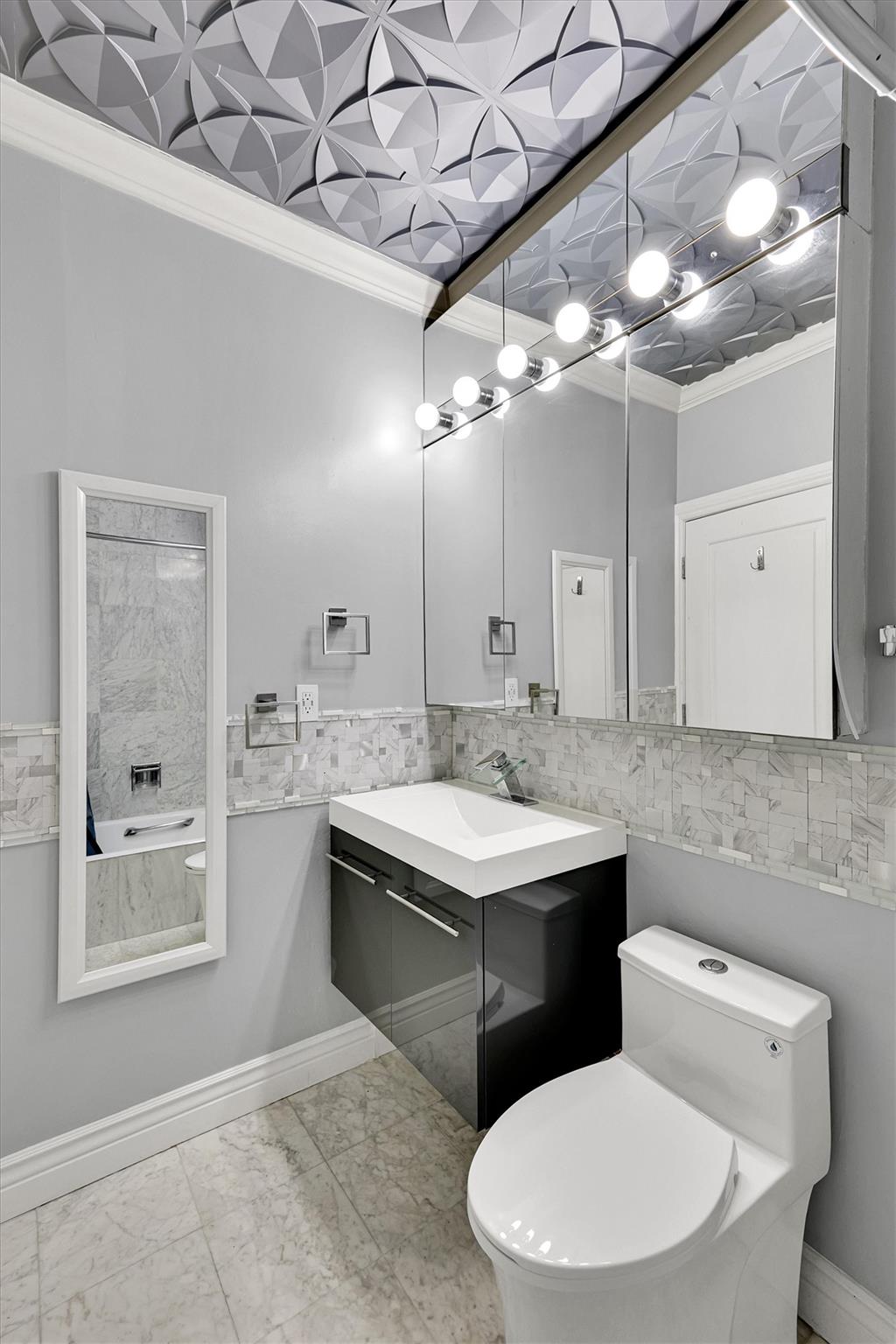 380 Rector Place, Unit 15E Manhattan, NY 10280 - Photo 31 of 31 Bathroom featuring vanity, baseboards, crown molding, toilet, and marble finish floor