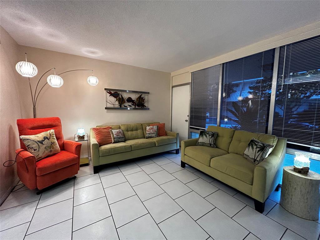 4630 Poinciana Street, Unit 1C Lauderdale-by-the-Sea, FL 33308 - Photo 4 of 7 a bedroom with furniture and a couch