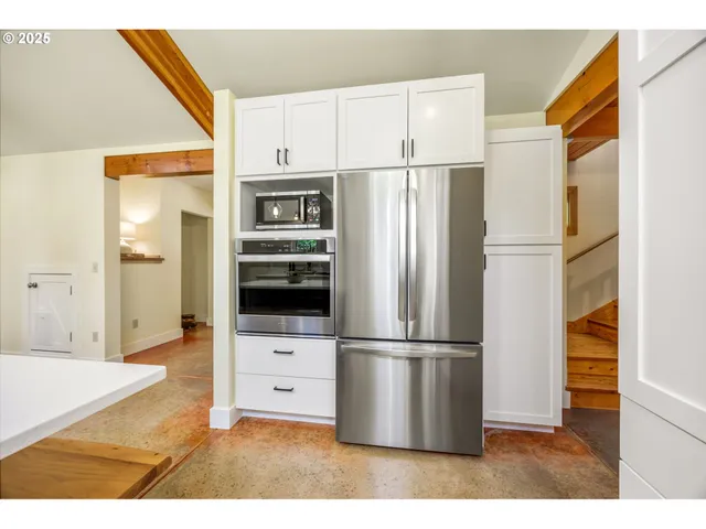 a kitchen with stainless steel appliances a refrigerator and a stove top oven