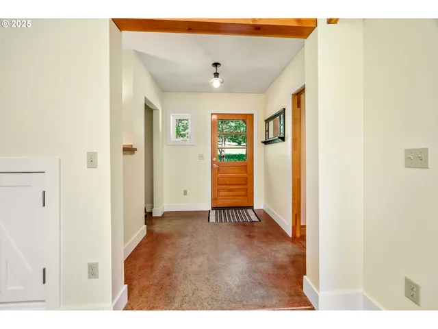 a living room with furniture a window and a table