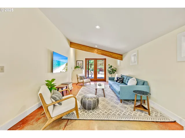a living room with furniture and a large window