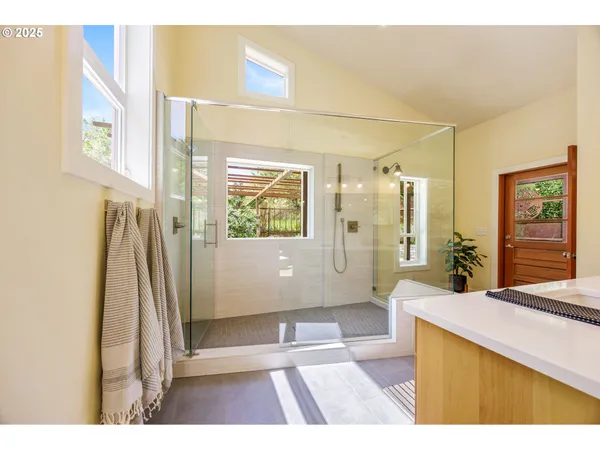 a bathroom with a double vanity sink mirror and bathtub