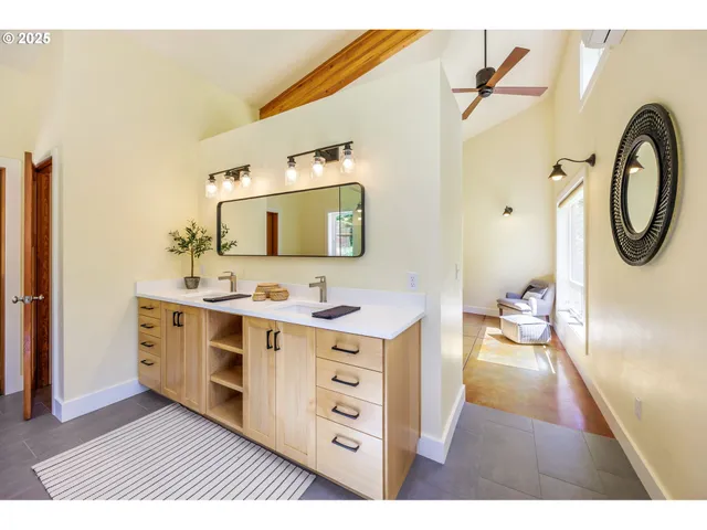 a large bathroom with a double vanity sink a mirror and a shower