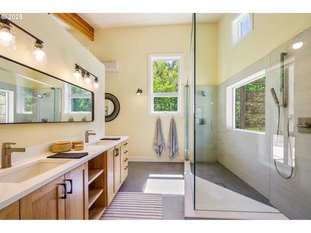 a spacious bedroom with a bed a window and dresser