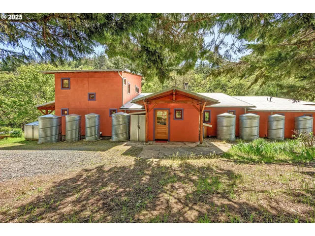 a view of a yard in front of a house with large trees