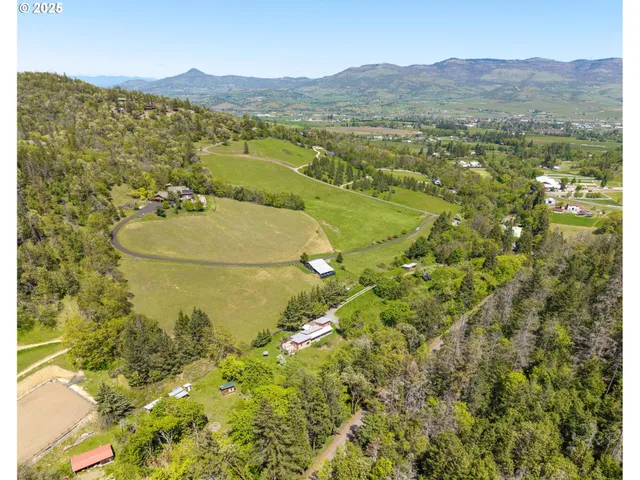 a aerial view of a house with a yard and lake view