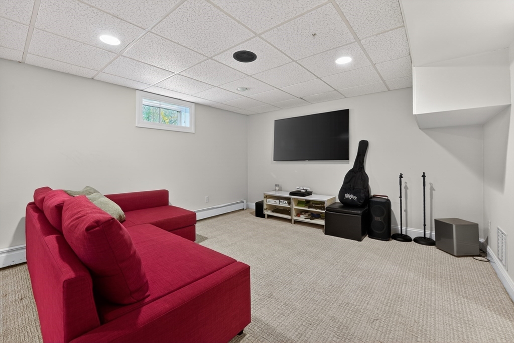 71 Robert Best Road Sudbury, MA 01776 - Photo 21 of 31 a living room with furniture and a flat screen tv