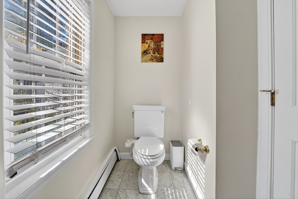 71 Robert Best Road Sudbury, MA 01776 - Photo 24 of 31 a bathroom with a toilet and a shower curtain