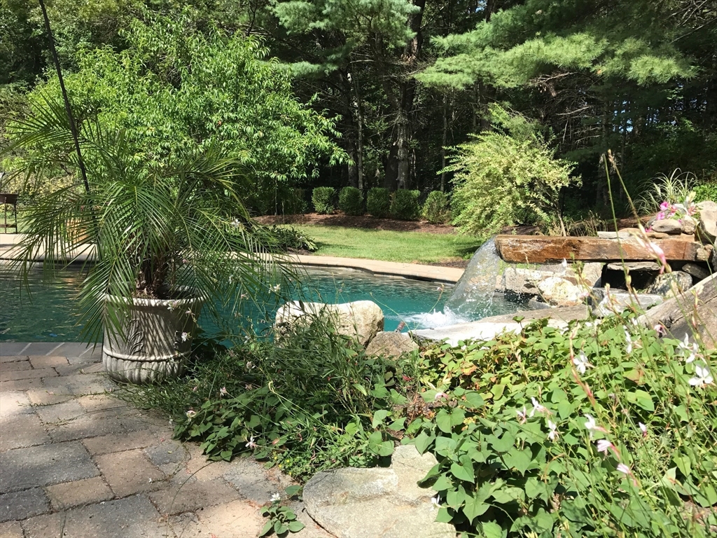 71 Robert Best Road Sudbury, MA 01776 - Photo 29 of 31 a view of a garden with a bench