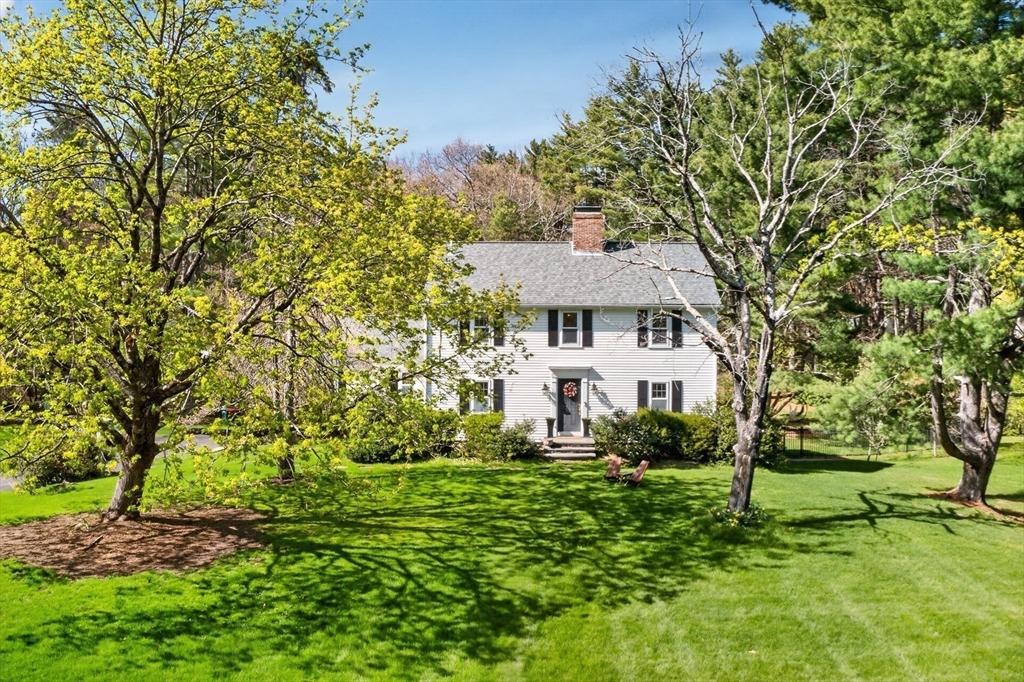 71 Robert Best Road Sudbury, MA 01776 - Photo 31 of 31 a view of a white house with a big yard and large trees