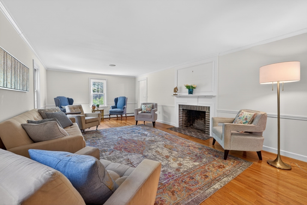 71 Robert Best Road Sudbury, MA 01776 - Photo 10 of 31 a living room with furniture and a fireplace