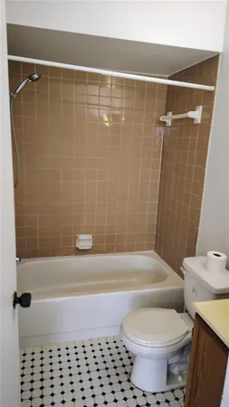 a view of hallway with a window and a refrigerator