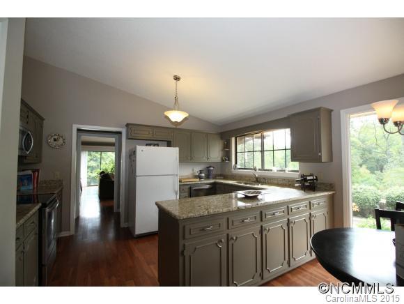 1201 New Market Road Tryon, NC 28782 - Photo 3 of 19 a kitchen with a sink stove and refrigerator