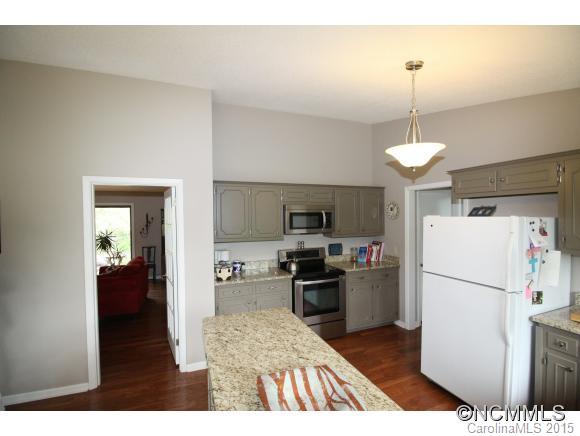 1201 New Market Road Tryon, NC 28782 - Photo 4 of 19 a open kitchen with refrigerator stove microwave and cabinets