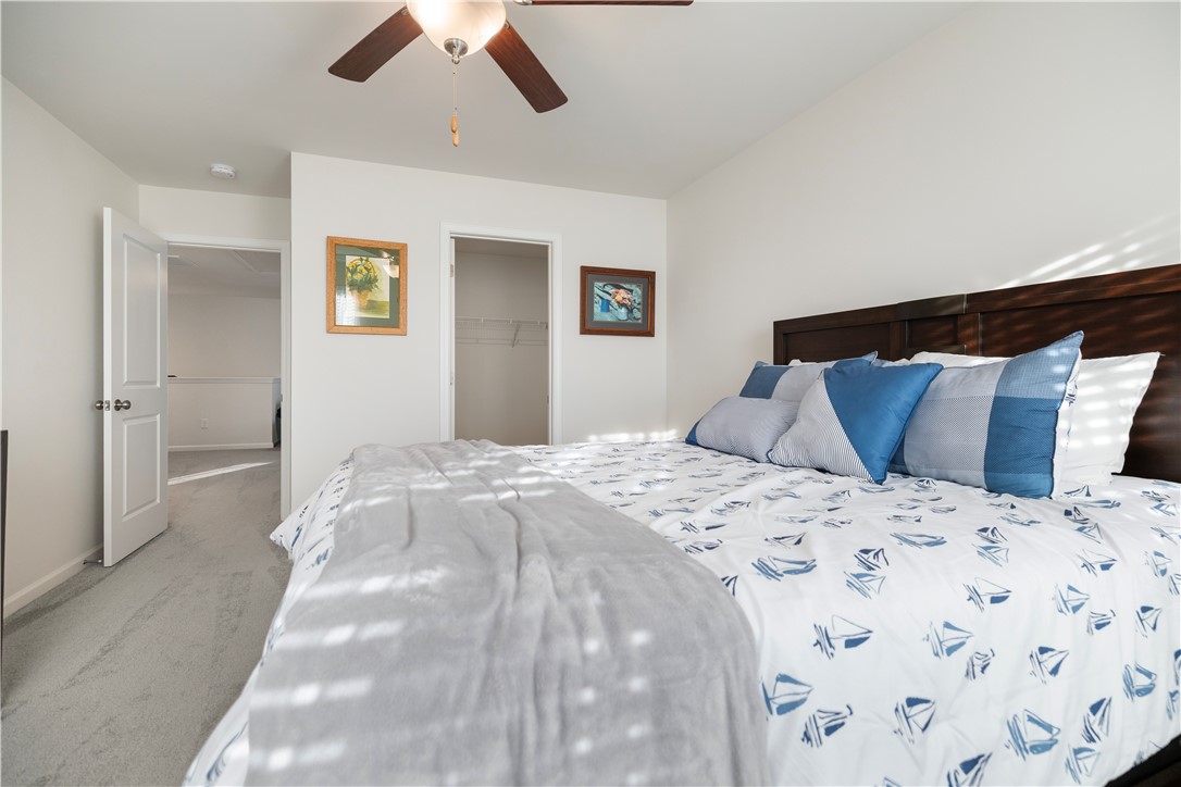 104 Village Main Anderson, SC 29621 - Photo 21 of 32 This serene bedroom offers a comfortable retreat with soft carpet flooring and a convenient walk-in closet.