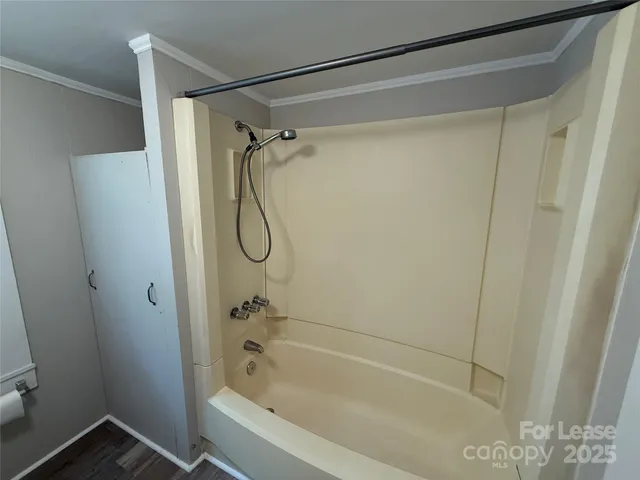 a bathroom with a shower and a shower