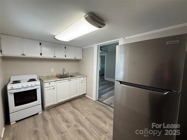 a kitchen with a sink a refrigerator and a stove