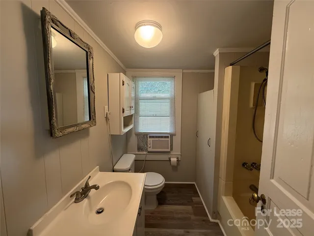 a bathroom with a tub sink and shower