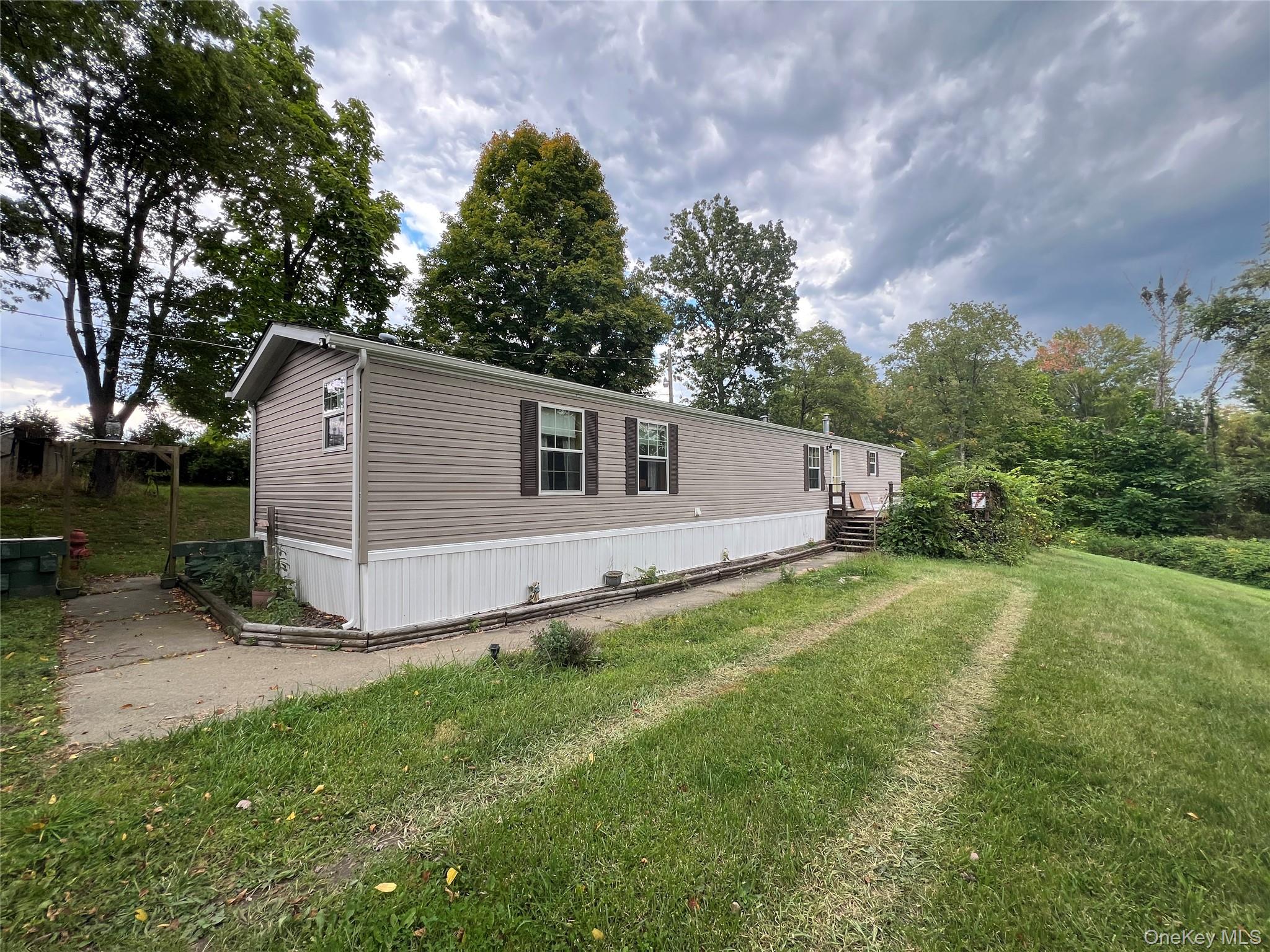 22 Samsonville Road, Unit 3 Kerhonkson, NY 12446 - Photo 1 of 1 View of property exterior featuring a lawn