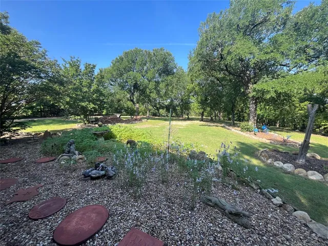 a view of a backyard with swimming pool