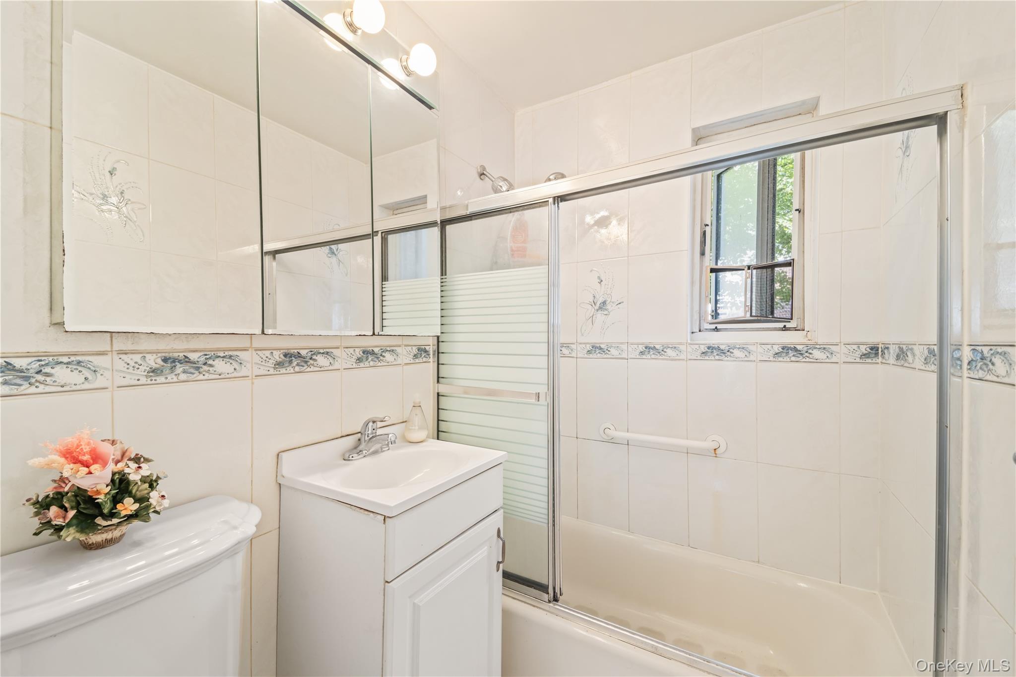 225-35 88th Avenue, Unit LOWR Queens, NY 11427 - Photo 13 of 15 a bathroom with a sink toilet and shower