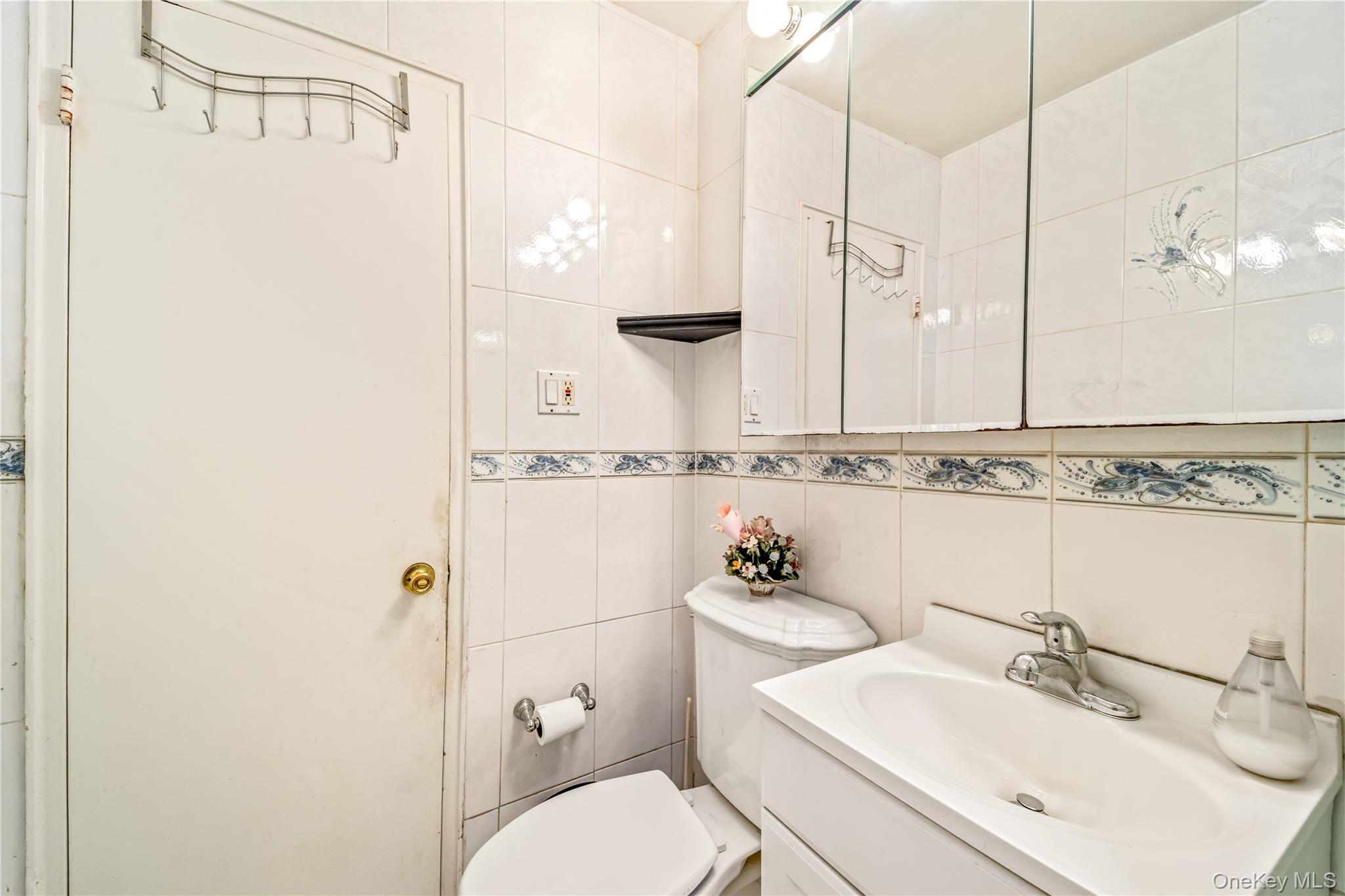 225-35 88th Avenue, Unit LOWR Queens, NY 11427 - Photo 14 of 15 a bathroom with a sink a toilet and shower