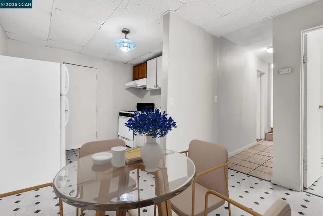 a kitchen with a sink a refrigerator and cabinets